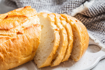 Sliced wheat bread on the white board.