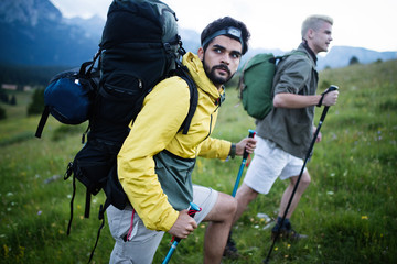 Man traveling with backpack hiking in mountains