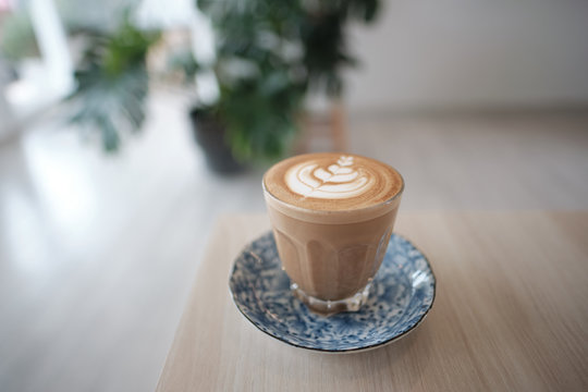 A cup of Picolo coffee on a wooden table