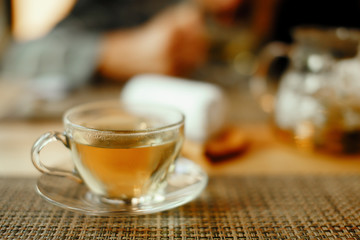 Green tea in a cup on wooden table