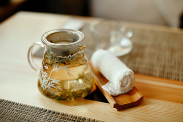 Green tea in a cup on wooden table