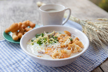 Breakfase meal. Congee or Rice porridge minced pork, boiled egg with soy milk and Chinese deep fried double dough stick
