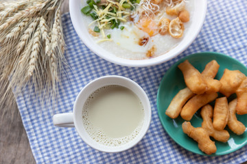 Breakfase meal. Congee or Rice porridge minced pork, boiled egg with soy milk and Chinese deep fried double dough stick