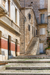 Fototapeta na wymiar Old stone houses in a charming alley, typical Mediterranean architecture, island Vis, Komiza, Croatia