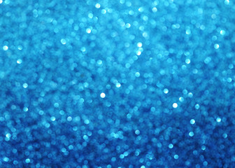 Blurred texture of glitter's paper. Festive background.