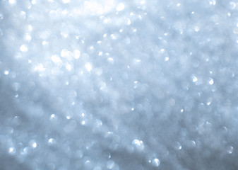 Blurred texture of glitter's paper. Festive background.