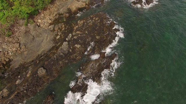 Coastal POV drone survey geology research university test flight along a rocky sea ocean front beach shore with waves crashing on land