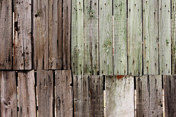 old wooden panel of the fence made of natural wood aged by the natural process for a long time