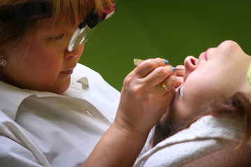 Eyelash extension procedure, woman eye with Long eyelashes