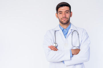 Portrait of young bearded Persian man doctor with arms crossed