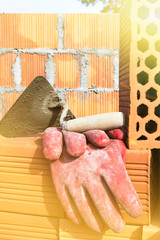 Mason bricklaying background with trowel and clay brick blocks