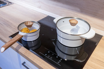 Metal Pot on induction hob in modern kitchen. modern kitchen pot cooking induction electrical stove...