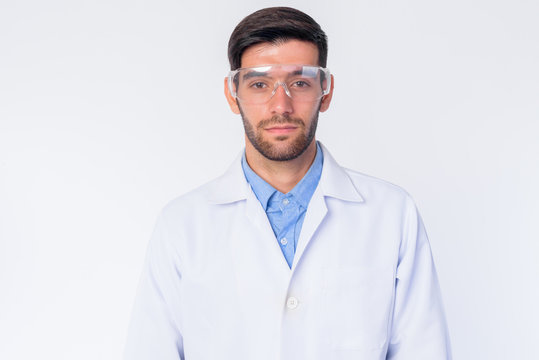 Young bearded Persian man doctor as scientist looking at camera