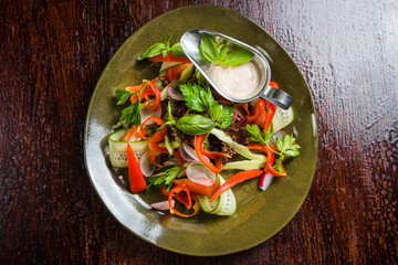 Fresh salad on ceramic plate