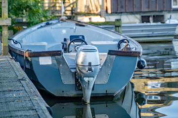 Fototapeta na wymiar 1 Close up of a small pleasure boat moored up on a small lake