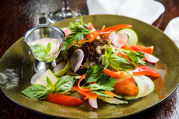 Fresh salad on ceramic plate
