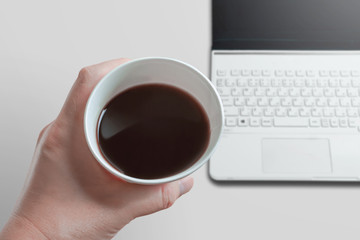 Drinking coffee at the desk or table.   デスクまたはテーブルでコーヒーを飲む。