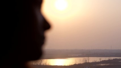 Blurred portrait of passenger woman against rural outdoors seen through window. Dreamy lady travel by high speed train from Shanghai to Beijing. Bright evening sun shine through thick dusty air - Powered by Adobe