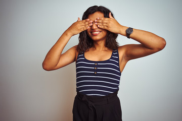 Transsexual transgender woman wearing striped t-shirt over isolated white background covering eyes with hands smiling cheerful and funny. Blind concept.