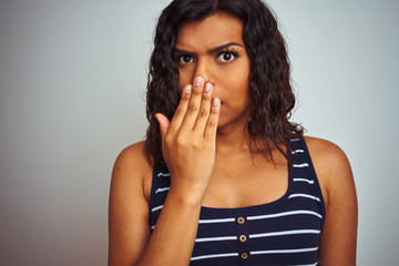 Beautiful transsexual transgender woman wearing striped t-shirt over isolated white background cover mouth with hand shocked with shame for mistake, expression of fear, scared in silence