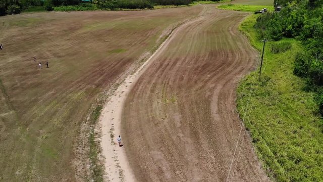 Drone Shot girl walking to the beach