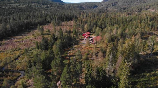 Aerial view over Heisetra cabins with lots of beautiful pine trees and forest surrounding the cabins, in Kodal, Norway
