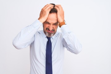 Middle age businessman wearing elegant tie standing over isolated white background suffering from headache desperate and stressed because pain and migraine. Hands on head.