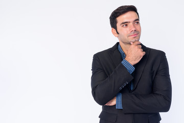 Portrait of young handsome Persian businessman in suit thinking