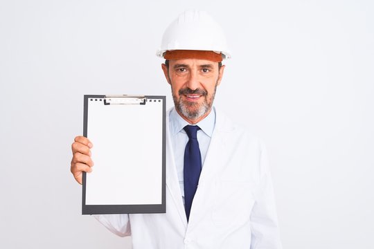 Senior engineer man wearing security helmet holding clipboard over isolated white background with a confident expression on smart face thinking serious