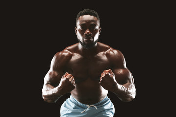 Fototapeta na wymiar Professional bodybuilder posing on camera, flexing muscles