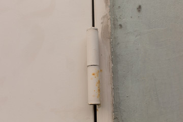 Steel door hinge on a swing door for exterior design. Horizontal shot.