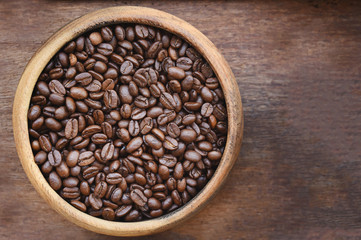 Close up of coffee beans in wooden bowl