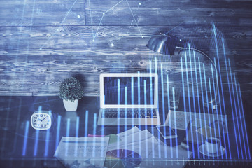 Double exposure of graph and financial info and work space with computer background. Concept of...