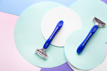 Composition with razors on color background
