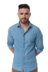 Fototapeta premium casual man standing with hands behind him mysterious