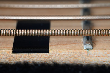 Strings of bass guitar and frets in detail.