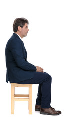 businessman sitting and looking ahead while holding hands serious