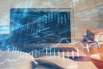 Forex market chart hologram and personal computer background. Multi exposure. Concept of investment.