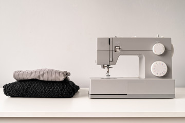 sewing machine on tailor table with fabric with copy space