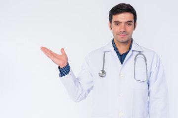 Fototapeta premium Portrait of young Persian man doctor showing something
