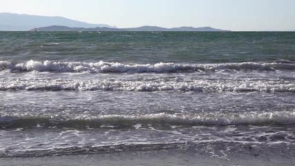 Ocean beach with foamy wave in the early morning
