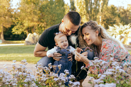 Happy family father, mother and child daughter outdoor  enjoying  sunset  - Image