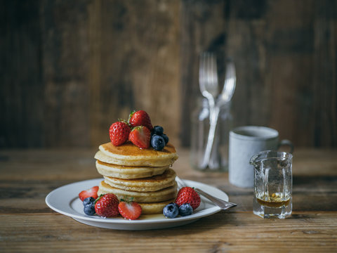 pancakes topped with strawberry and blueberry