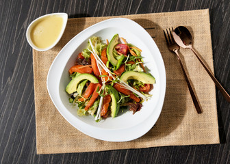 Smoked salmon with mixed lettuce, avocado, capers, and onion