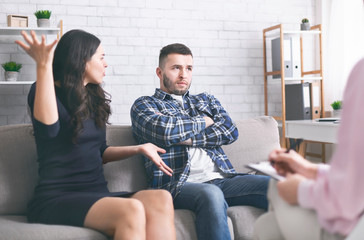 Young millennial couple arguing at psychotherapist session