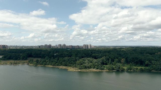 a shot with my drone mavic 2 zoon to a lake with trees and the city on the horizon