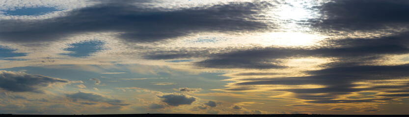 Fototapeta premium Leaden, storm clouds covered the sunset. Cumuliform cloudscape on blue sky. The terrain in southern Europe. Fantastic skies on the planet earth. Tragic gloomy sky.