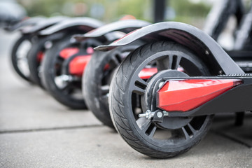 Wheels of parked electric scooters.