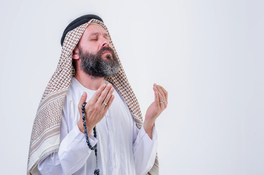 Praying hands of an old arabic man.Indoor picture.