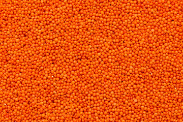 Red lentils background, top view. Close-up.
